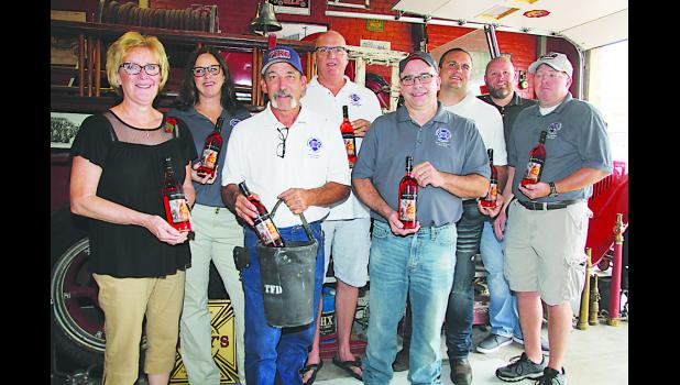 LODD Team members are pictured with Loretta McDowell Miletta Vista Winery holding Heroes series wine. Pictured from left to right are: Loretta McDowell, Roseanne Scurto, Ron Tubbs, Terry Zwiebel, Toby Watts, Fred Benzel, Casey Ryan and Mikey Eytcheson.