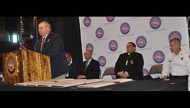 NSVFA President Scott Schremmer is pictured at the microphone at opening ceremonies of Nebraska Fire School.