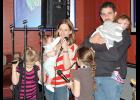 Adam and Sadie (Clark) McGruder offer their thanks at Saturday’s fundraiser in Gayville for those who have supported their family after they lost their home and possessions in a Jan. 14 house fire. The McGruders are joined on stage by daughters Fayth, 8; Cassidy, 7; Autumn, 5; Grace 1 1/2 and Evalyn, 7 months.