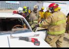 The extrication class at the Agra fire school works on a car.