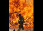 This photo was taken during a controlled burn of a barn by the Akron Fire Department. A 80 plus year old barn was burned. The photo makes it look like the firefighter is much closer to the fire than he actually was. See more photos inside. Photo by Tami Small, wife of Akron Fire Department Assistant Chief Bruce Small.