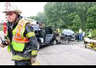 Communication between various agencies is essential. In this photo, Clear Lake (Iowa) Assistant Fire Chief Mike Keefe radios for assistance at the scene of a two-vehicle accident on Highway 18 West on Aug. 5. The head-on collision sent four people to the hospital. Ambulances from Clear Lake and Mason City responded to the scene investigated by the Iowa State Patrol. Photo by Chris Barragy of the Clear Lake Mirror Reporter.