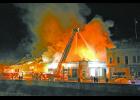 A ladder truck sprays water onto the burning roof of The Vault building in downtown Hot Springs at around 10:30 p.m. on Monday, Feb. 17. See more photos and story inside this issue. Photo by Brett Nachtigall, Publisher of the Fall River County Herald-Star.	