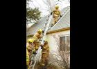 During roof ventilation training, Tim Rotert, Layton Schimke and Ryan Jungemann practice drills to ventilate a smoke-filled house.