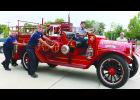 Hays firefighters help steer and push a 1921 REO Speedwagon that served as the first motorized fire truck for the Hays Fire Department back into the fire station after a presentation. Photo by Jolie Green of the Hays Daily News.