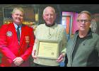 On Saturday, Dec. 11, IFA 1st vice-president Chuck Raska (left) presented Emil Richter with a meritorious service award for 50 years of service to the Milford Fire Department. At right is Milford Fire Chief Jim Carpenter.