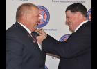 	Outgoing President Shad Bryner (right) puts the President’s pin on Scott Schremmer.