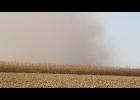 Smoke rises from a grass/field fire behind a field of corn south of Ewart in Poweshiek County. The fire burned approximately 500 acres before being extinguished by firefighters from three counties. This photo courtesy of Dann Hayes.
