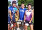 IFA 2nd vice-president Mark McNees (left) and IFA Executive Director Wendy Lensing (right) stopped during RAGBRAI in Strawberry Point to visit with Strawberry Point firefighter/Senator Mike Breitbach.