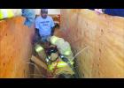 Matt Taggart of Vermillion guides a firefighter through an entanglement prop in the Firefighter Survival Class.
